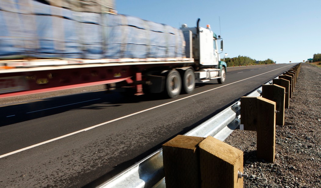 A transport truck with a trailer driving on the highway